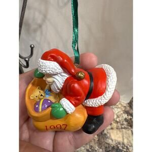 1997 Limited Edition Opening His Pack Christmas Holiday Ornament by Dana Nelson